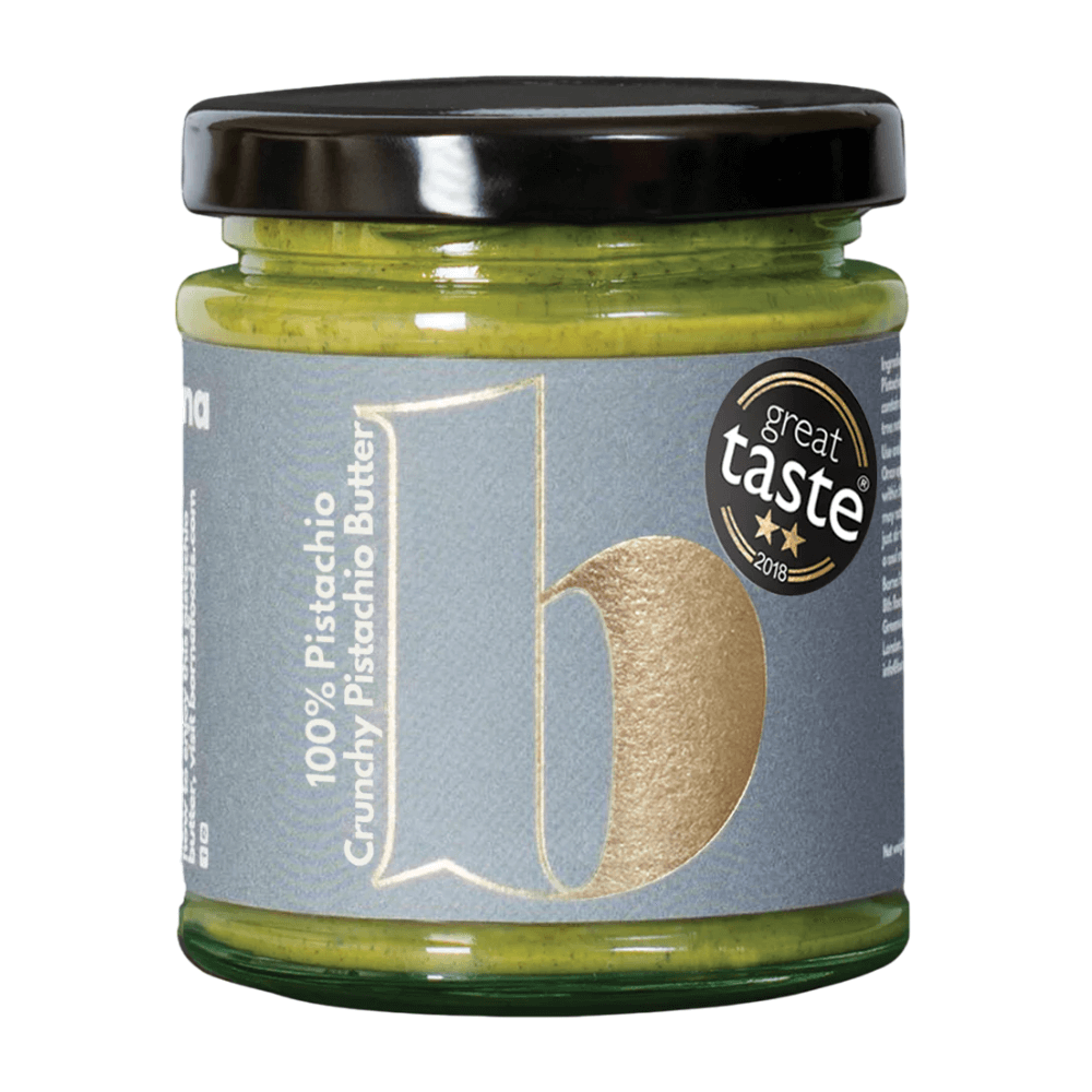 Jar of pistachio butter with a 'great taste' award label on a white background