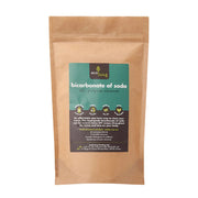 Kraft paper package of bicarbonate of soda with a green label on a white background