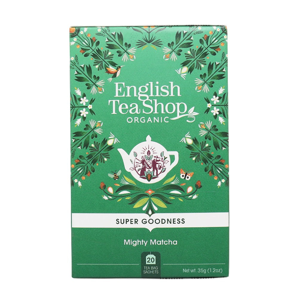 Green packaging of English Tea Shop Organic Mighty Matcha tea with decorative elements on a white background