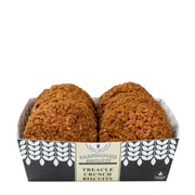 Two treacle crunch biscuits in a decorative box on a white background