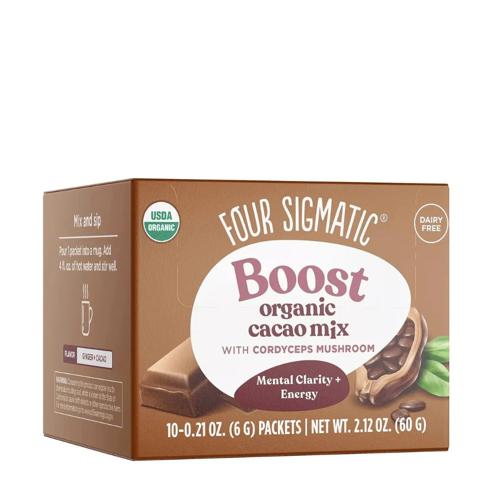Box of Four Sigmatic Boost organic cacao mix with cacao bar and green leaf on a white background