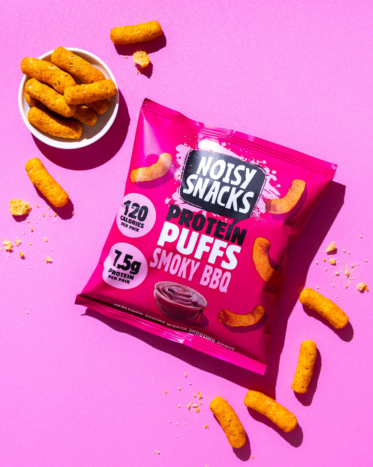 Noisy Snacks Smoky BBQ Protein Puffs served in a bowl