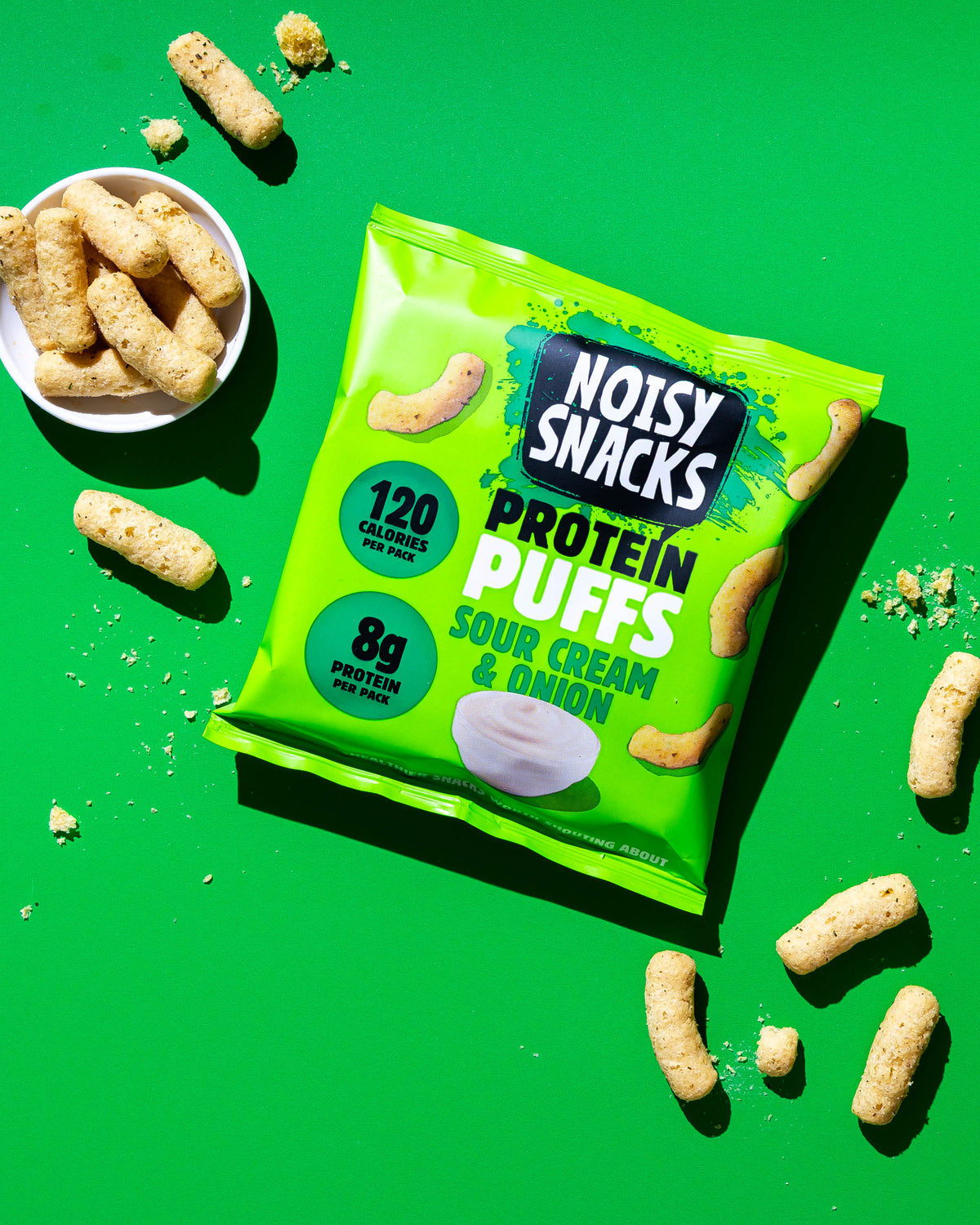 Noisy Snacks Sour Cream & Onion Protein Puffs served in a bowl