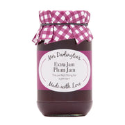 Jar of plum jam with a pink checkered lid on a white background