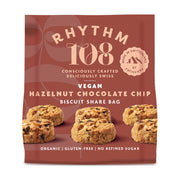 Packaging of Rhythm 108 vegan hazelnut chocolate chip biscuits on a red background