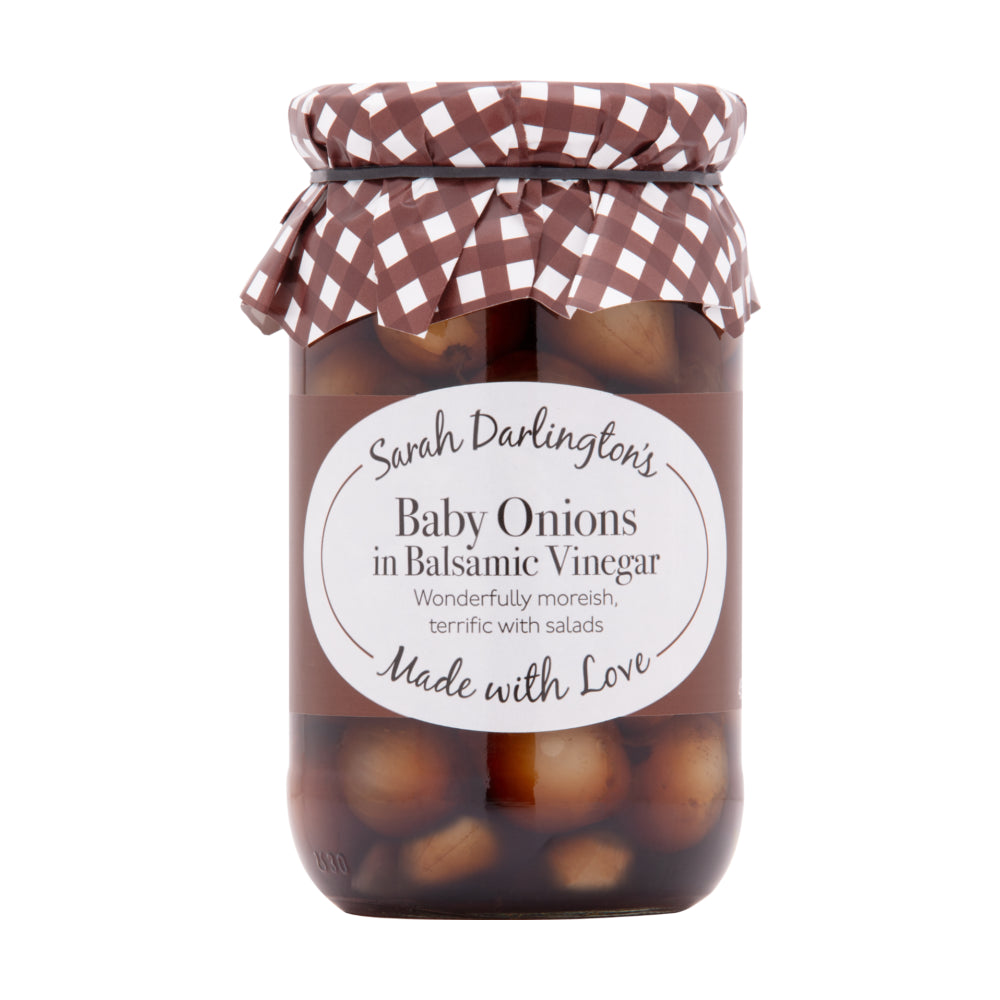 Jar of baby onions in balsamic vinegar with a checkered lid on a white background