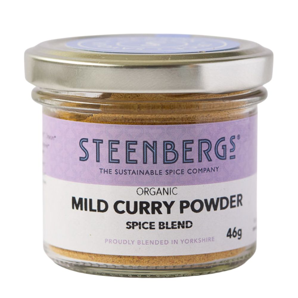 Steenbergs organic mild curry powder spice blend in a glass jar on a white background