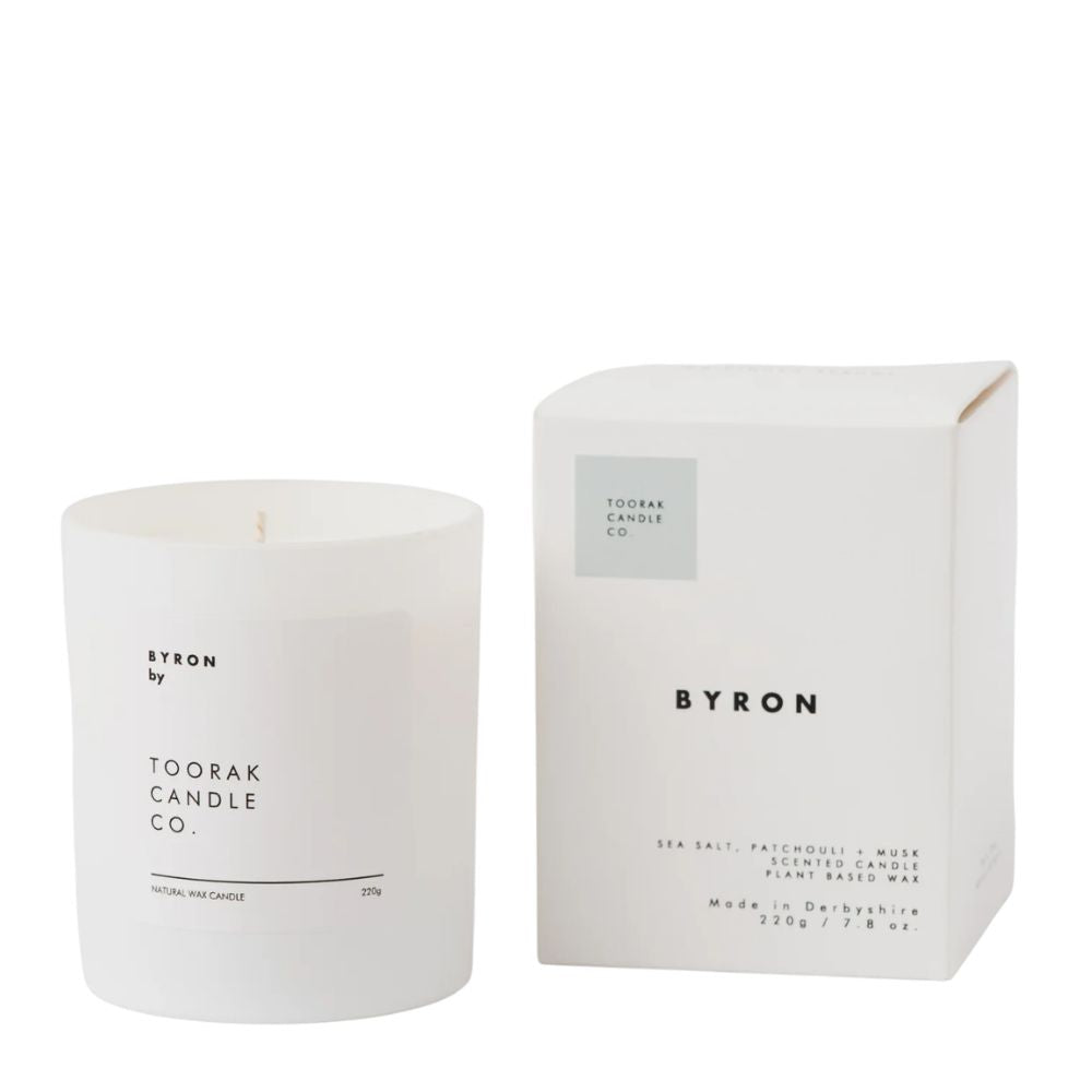 White candle and packaging with 'Byron' branding on a white background