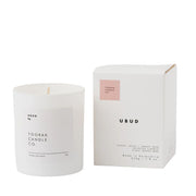 White candle and packaging with 'UBUD' branding on a white background