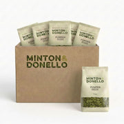 Minton & Donello pumpkin seed packages in a cardboard box on a white background