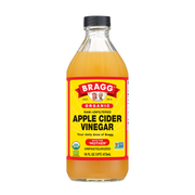 Bottle of Bragg Organic Raw Unfiltered Apple Cider Vinegar on a white background