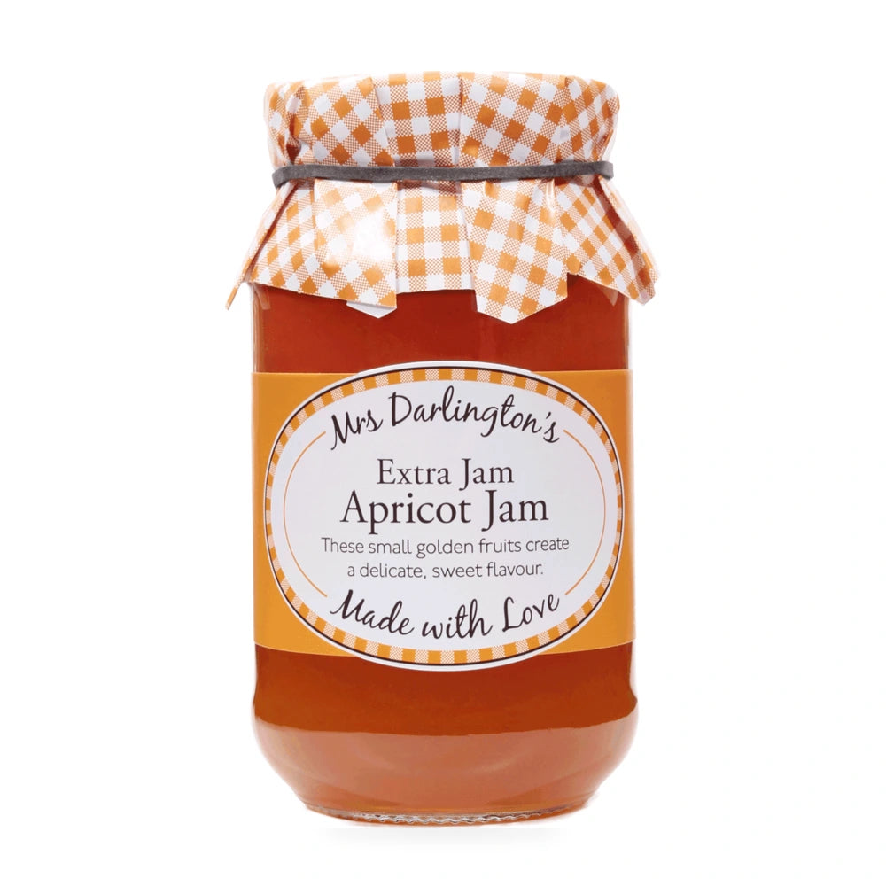 Jar of apricot jam with a checkered lid on a white background