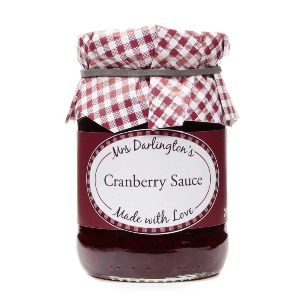Jar of cranberry sauce with a checkered lid on a white background