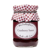 Jar of cranberry sauce with a checkered lid on a white background
