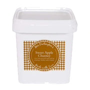 White container with a label for sweet apple chutney on a white background