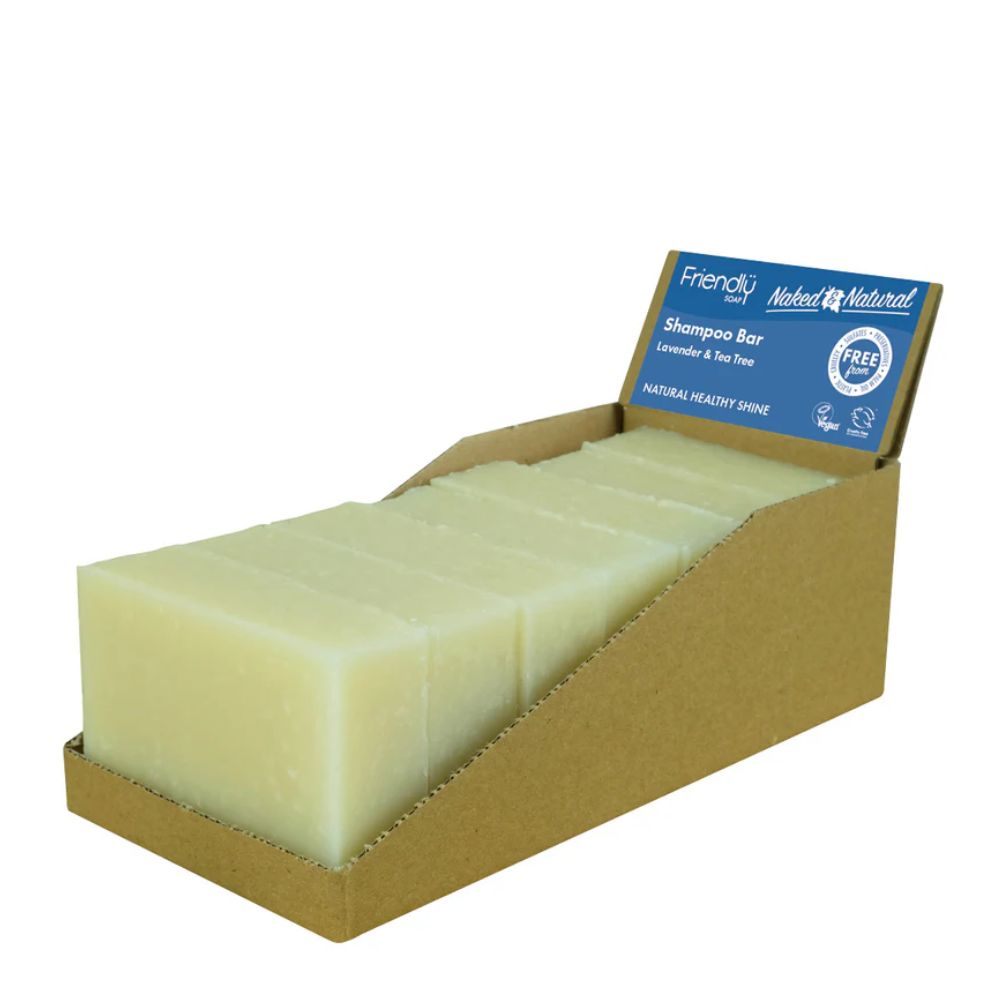 A cardboard display box holding multiple pale yellow shampoo bars, with a blue product label visible at the top. The label reads Friendly and Natural and identifies the item as a shampoo bar.